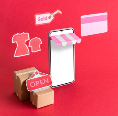 Shoputensilien und Smarthone auf pinkem Hintergrund symbolisieren Verkaufsförderung